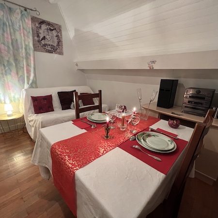 L'Escale en amoureux - soirée douce et tranquille à 2 Vue sur une table carrée et 4 assiettes vertes avec bougies pour escale amoureux